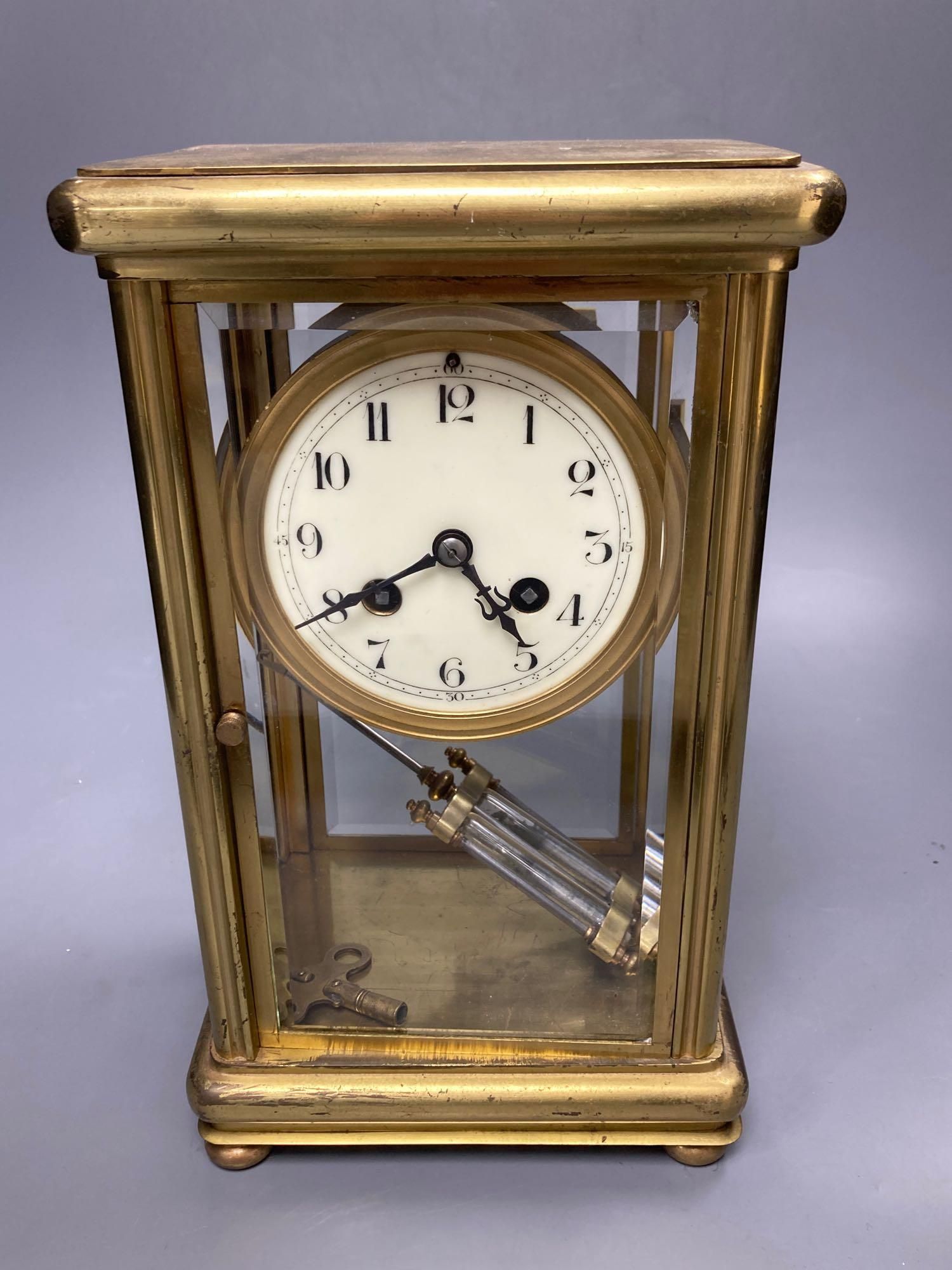 A four glass and brass mantel clock with mercury pendulum, 18cm high, 17cm wide,13cm deep